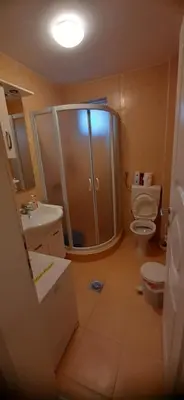 a bathroom with a shower and a toilet and a sink at Apartmani Paradise in Sutomore