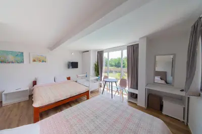 a bedroom with two beds and a table and a mirror at The Rock Star's Villa with Private Pool and Beach in Danilovgrad