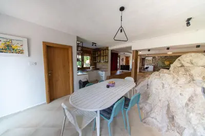 a kitchen and dining room with a table and chairs at The Rock Star's Villa with Private Pool and Beach in Danilovgrad