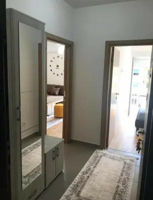 a room with a mirror and a living room at KENZA jednosobni stanovi in Podgorica