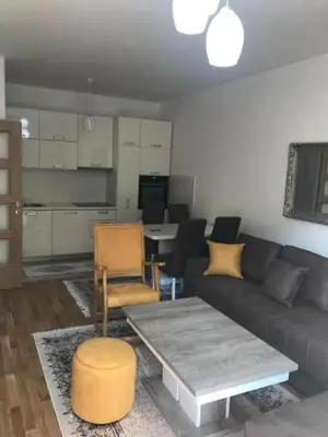 a living room with a couch and a table at KENZA jednosobni stanovi in Podgorica