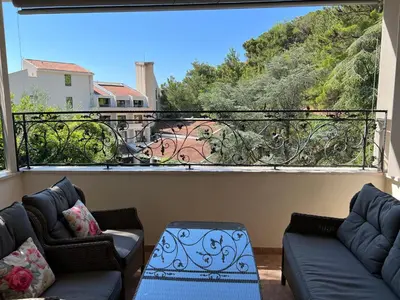 a living room with two couches and a large window at Vista Petrovac in Petrovac na Moru