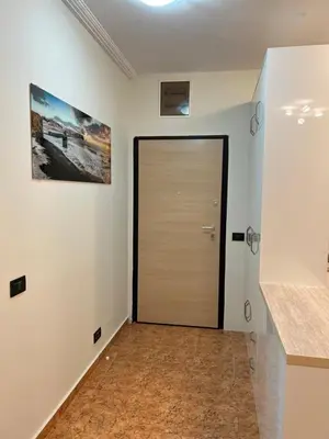 a hallway with a wooden door in a room at Vista Petrovac in Petrovac na Moru
