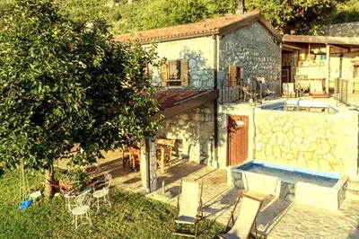 a house with a yard with a table and chairs at Old stone house with swimming pool Etno House Perazic in Bar