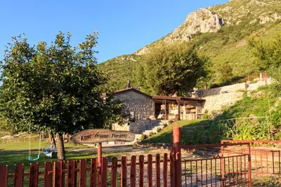 a fence with a sign in front of a house at Old stone house with swimming pool Etno House Perazic in Bar