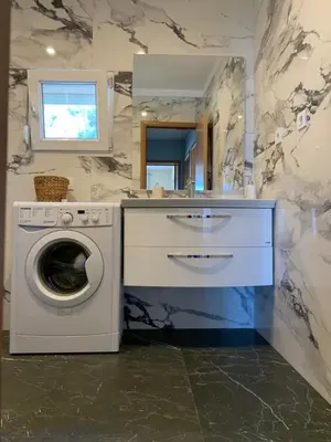 a bathroom with a washing machine and a sink at Apartment Serenada in Bar, Susanj