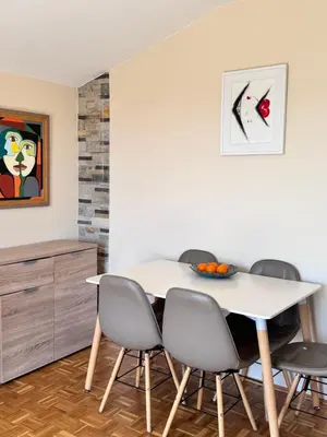 a dining room with a white table and chairs at Apartment Serenada in Bar, Susanj