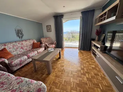 a living room with a couch and a table at Apartment Serenada in Bar, Susanj