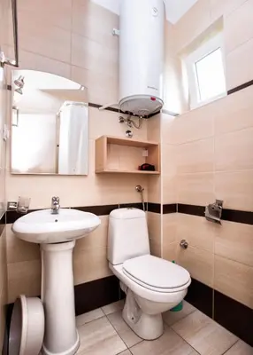 a bathroom with a toilet and a sink and a mirror at Apartments Đurović in Petrovac na Moru