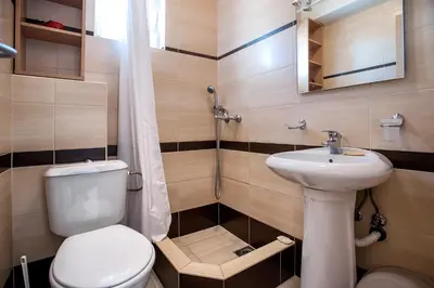 a small bathroom with a toilet and a sink at Apartments Đurović in Petrovac na Moru