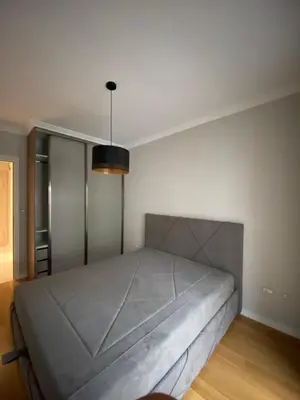 a bedroom with a large bed in a room at Apartman VT Central point in Podgorica