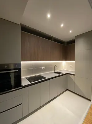 a kitchen with white cabinets and a sink at Apartman VT Central point in Podgorica