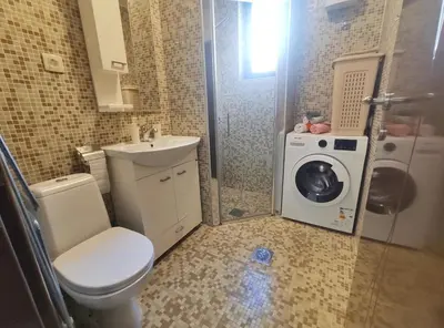 a bathroom with a toilet and a washing machine at Petrovac Sea in Petrovac na Moru