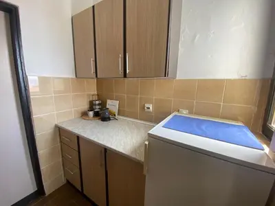 a small kitchen with a counter and a dishwasher at Two-bedroom apartment with parking and sea view in Becici