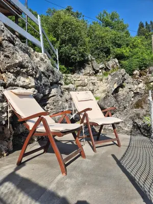 two chairs sitting next to each other on a patio at Old house, Skadar Lake in Cetinje