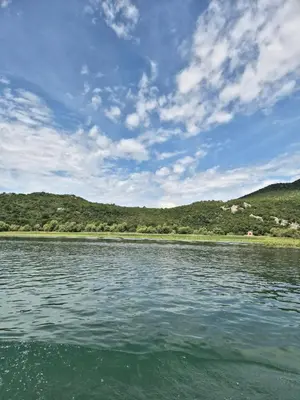 a large body of water with mountains in the background at Old house, Skadar Lake in Cetinje