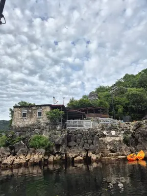 a house on a rocky island in the water at Old house, Skadar Lake in Cetinje