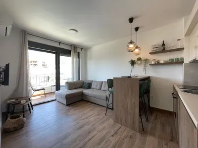 a kitchen and living room with a couch and a table at YOUR CHOICE in Bar