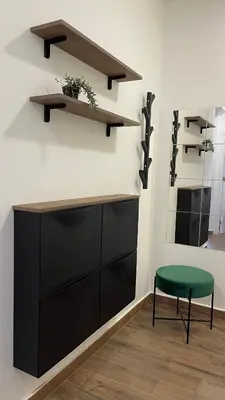 a room with a table and a stool and shelves at YOUR CHOICE in Bar