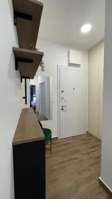a kitchen with a counter and a hallway with a door at YOUR CHOICE in Bar