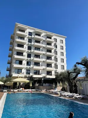 a hotel with a swimming pool in front of a building at YOUR CHOICE in Bar