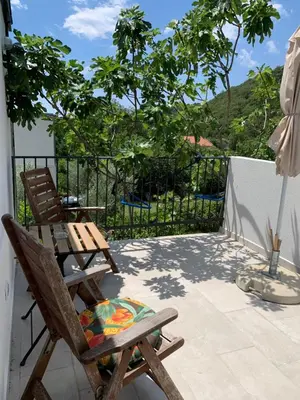a patio with a chair and an umbrella at Apartment Centar in Buljarica