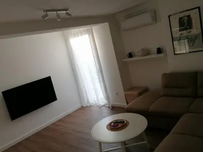 a living room with a couch and a table at Apartment Centar in Buljarica
