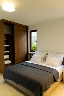 a bedroom with a large bed with a window at Villa Forte Mare in Petrovac na Moru