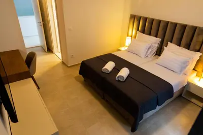 a bedroom with a bed with two pillows on it at Villa Forte Mare in Petrovac na Moru