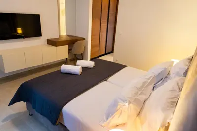 a bedroom with a bed with two towels on it at Villa Forte Mare in Petrovac na Moru