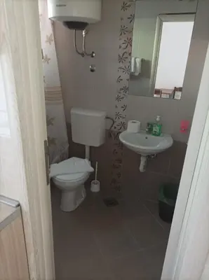 a bathroom with a toilet and a sink at Apartmani Baštrica in Budva