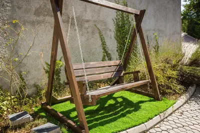a swing in a garden with green grass at Montana House Njeguši in Cetinje