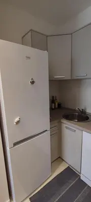 a kitchen with a white refrigerator and a sink at Todor apartment in Bar