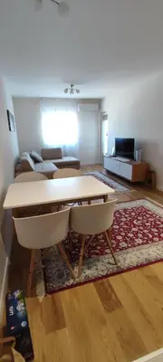 a living room with a table and a couch at Todor apartment in Bar