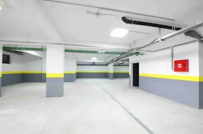 an empty parking garage with yellow and white walls at Lovely Partial Sea View one bedroom Flat in Horizon Residences A24 in Becici