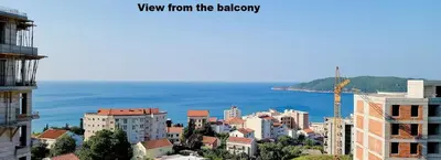 a view of a city with the ocean in the background at Lovely Partial Sea View one bedroom Flat in Horizon Residences A24 in Becici