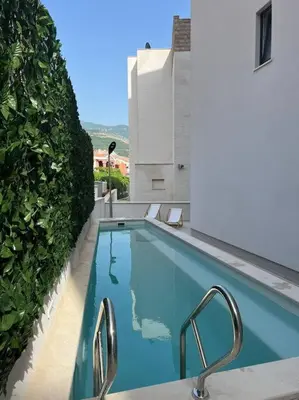 a swimming pool on the side of a building at Lovely Partial Sea View one bedroom Flat in Horizon Residences A24 in Becici