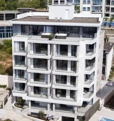 an aerial view of a white apartment building at Lovely Partial Sea View one bedroom Flat in Horizon Residences A24 in Becici