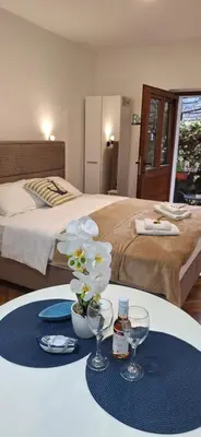 a hotel room with a bed and a table with glasses at Apartment Cattaro magico in Kotor