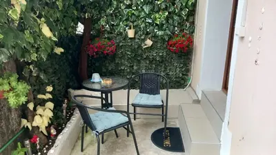a small table and two chairs on a patio at Apartment Cattaro magico in Kotor