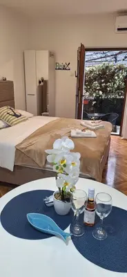 a table with a plate with a flower on it at Apartment Cattaro magico in Kotor