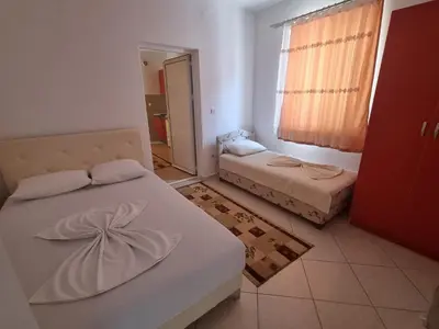 a small room with two beds and a window at Vila DUBAI - ULCINJ VELIKA PLAŽA in Ulcinj
