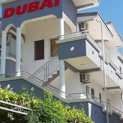 a building with a ducala sign on the side of it at Vila DUBAI - ULCINJ VELIKA PLAŽA in Ulcinj