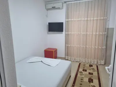 a small room with a bed and a window at Vila DUBAI - ULCINJ VELIKA PLAŽA in Ulcinj