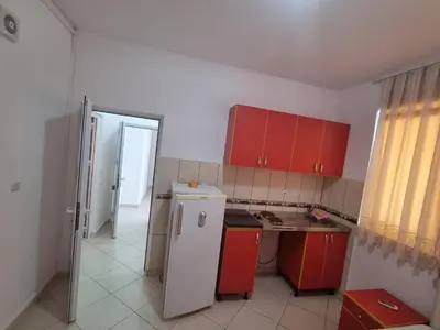 a kitchen with red cabinets and a white refrigerator at Vila DUBAI - ULCINJ VELIKA PLAŽA in Ulcinj