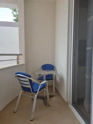 two chairs and a table in a room with a window at Vila DUBAI - ULCINJ VELIKA PLAŽA in Ulcinj