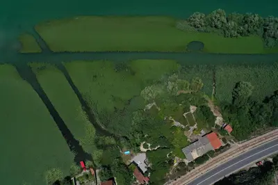 an aerial view of a house on an island next to a river at Lake House Buric in Vranjina