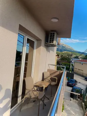 a balcony with chairs and a view of a city at Apartmani Orlović Bar in Bar