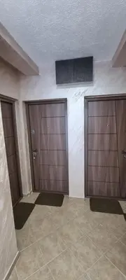 two garage doors in a room with tiled floors at Deluxe Apartmani Vila Pejovic Sutomore in Sutomore