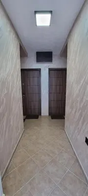 a room with three garage doors and a tile floor at Deluxe Apartmani Vila Pejovic Sutomore in Sutomore